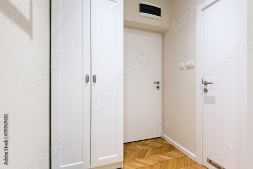 Entrance corridor with white closet