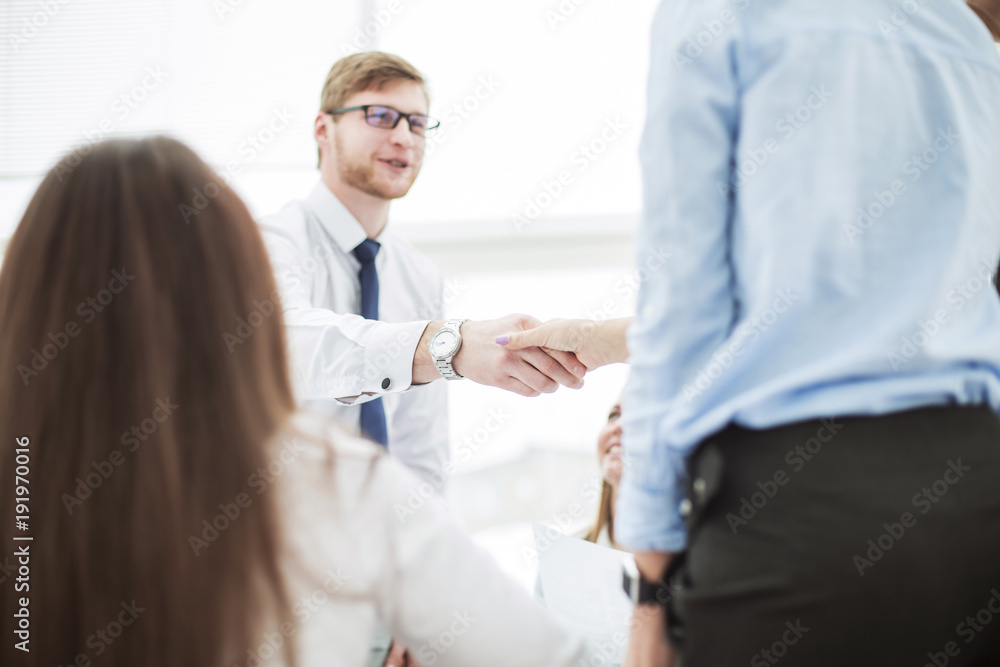  Bank Manager and the customer shake hands after signing a lucrative contract