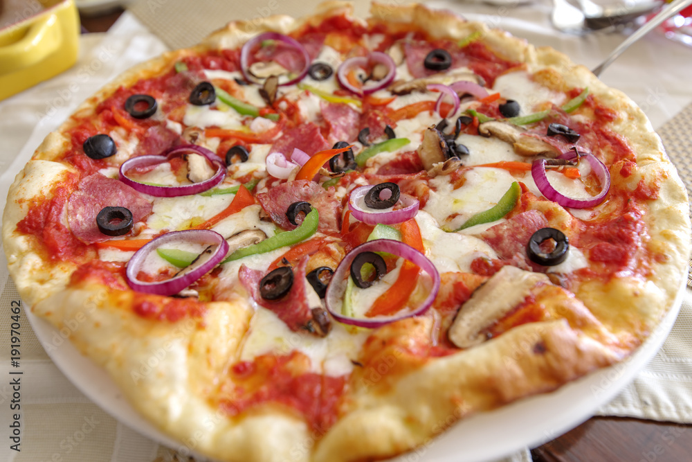 Italian style thin pizza on the table Italian style thin pizza on the table