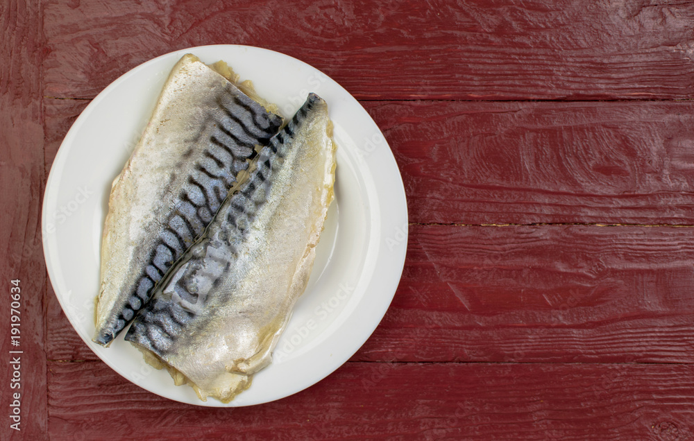 Marinated fish (mackerel) on a white plate.