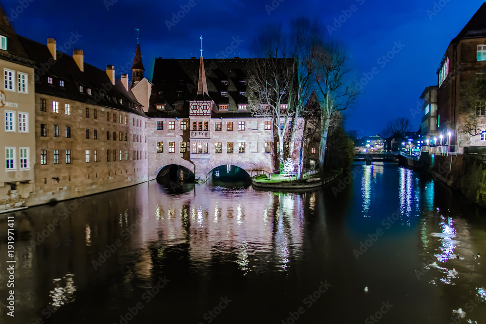 Fototapeta premium The Heilig-Geist-Spital at night in Nuremberg, Germany.