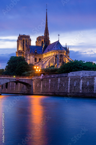 Long exposure photography of illuminated Notre-Dam Cathedral with beautiful evening sky
