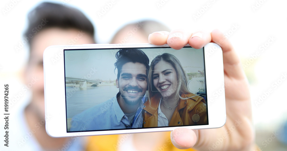 Couple in love taking selfies outdoors