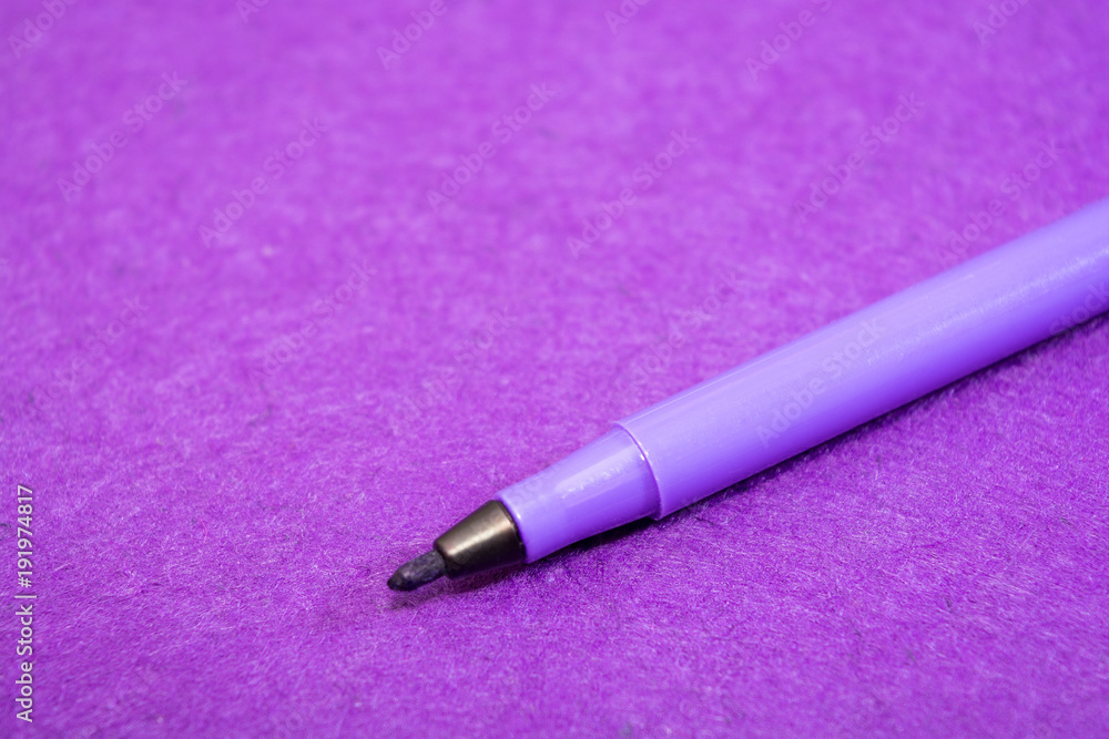 Violet felt pen on a purple felt background with space for text. Back to school. Art lessons. Violet felt pen on a purple felt background with space for text. Back to school. Art lessons.
