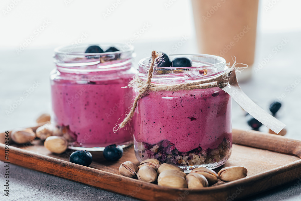 close-up view of healthy gourmet pink smoothie with granola, nuts and berries close-up view of healthy gourmet pink smoothie with granola, nuts and berries