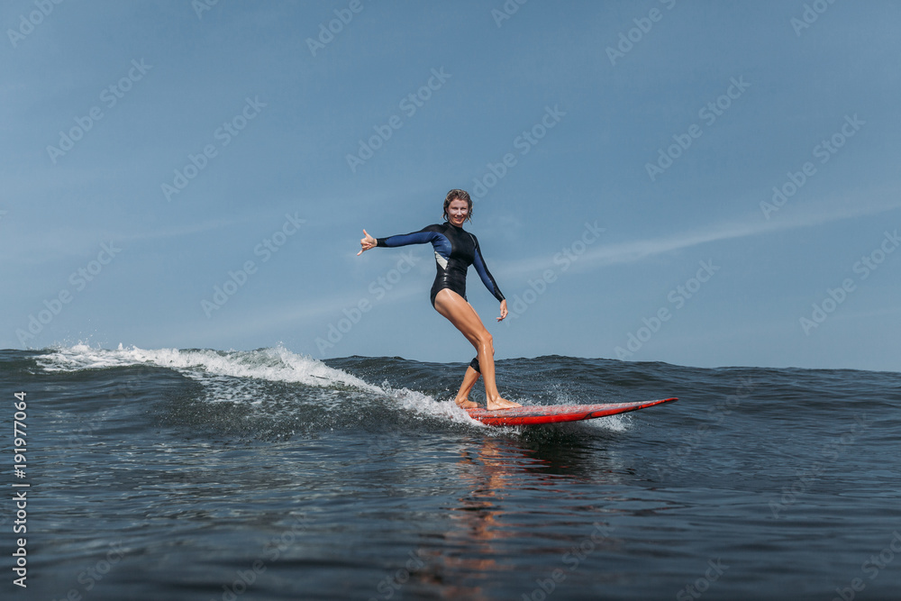 sports woman surfing wave in ocean
