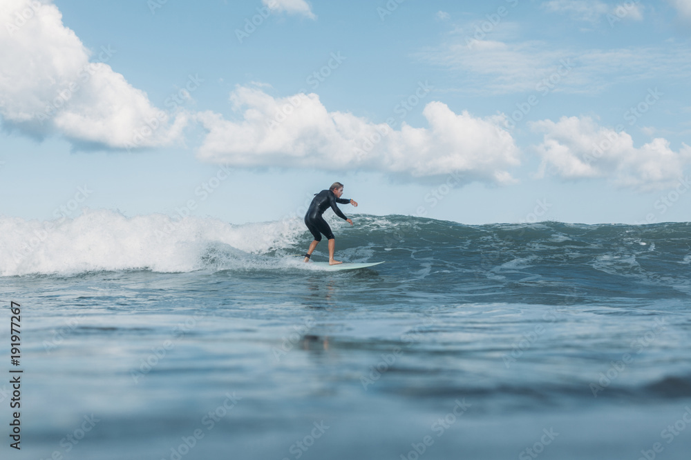 surfer riding wave on surf board in ocean surfer riding wave on surf board in ocean
