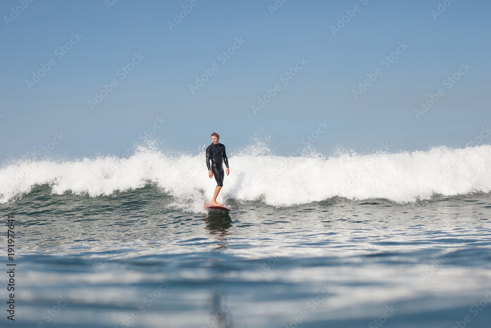 Fototapeta premium active man surfing wave in ocean
