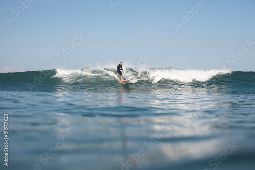 Photography active man surfing wave on board in ocean