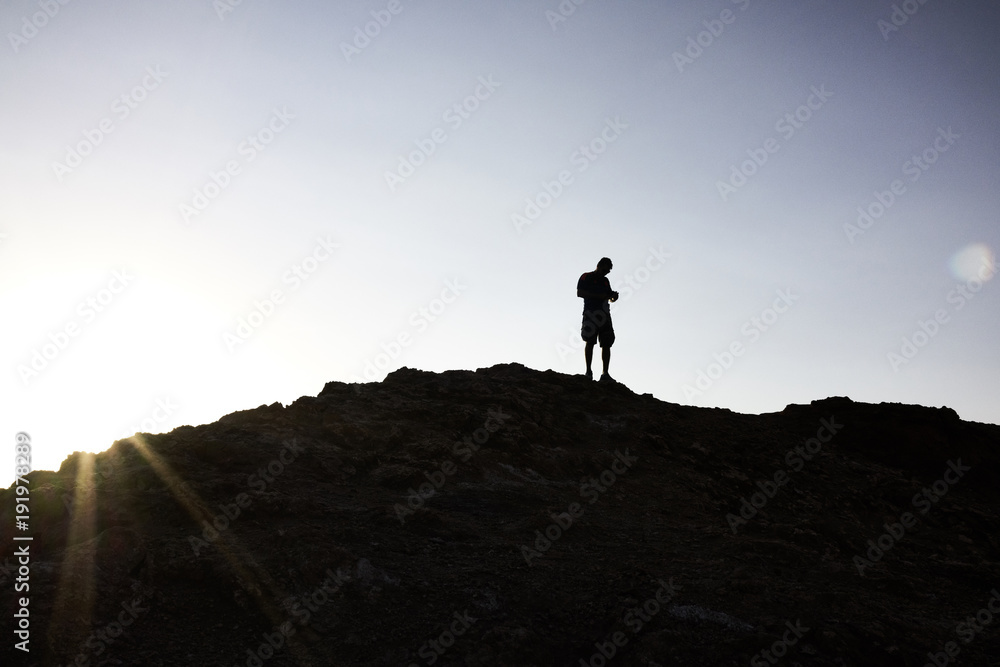 Silhouette of Man Atop a Hill in Atacama Sunrise