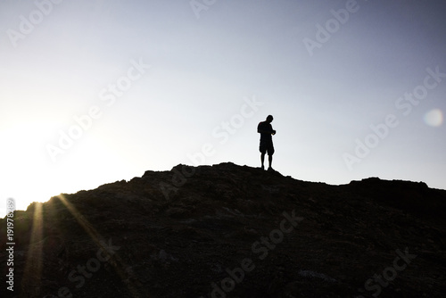 Silhouette of Man Atop a Hill in Atacama Sunrise