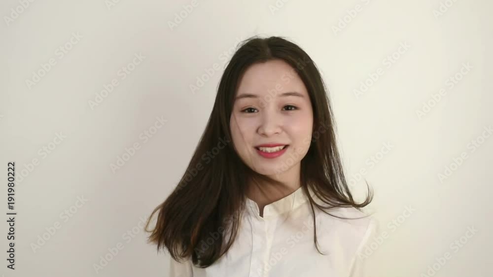 Young woman with long hair and a vivacious smile looking at the camera. Slow motion Young woman with long hair and a vivacious smile looking at the camera. Slow motion