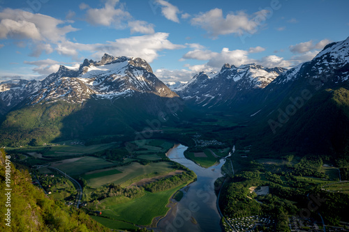 Beautiful view from the famous Rampestreken very close to the Nesakla peak, from where you can see the city Andalsnes city and the surroundings fjords and peaks.