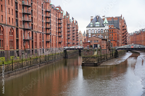 Speicherstadt. Port warehouse in Hamburg. Hamburg is a harsh German city. The urban landscape of northern Germany. View of city canals from the bridge.