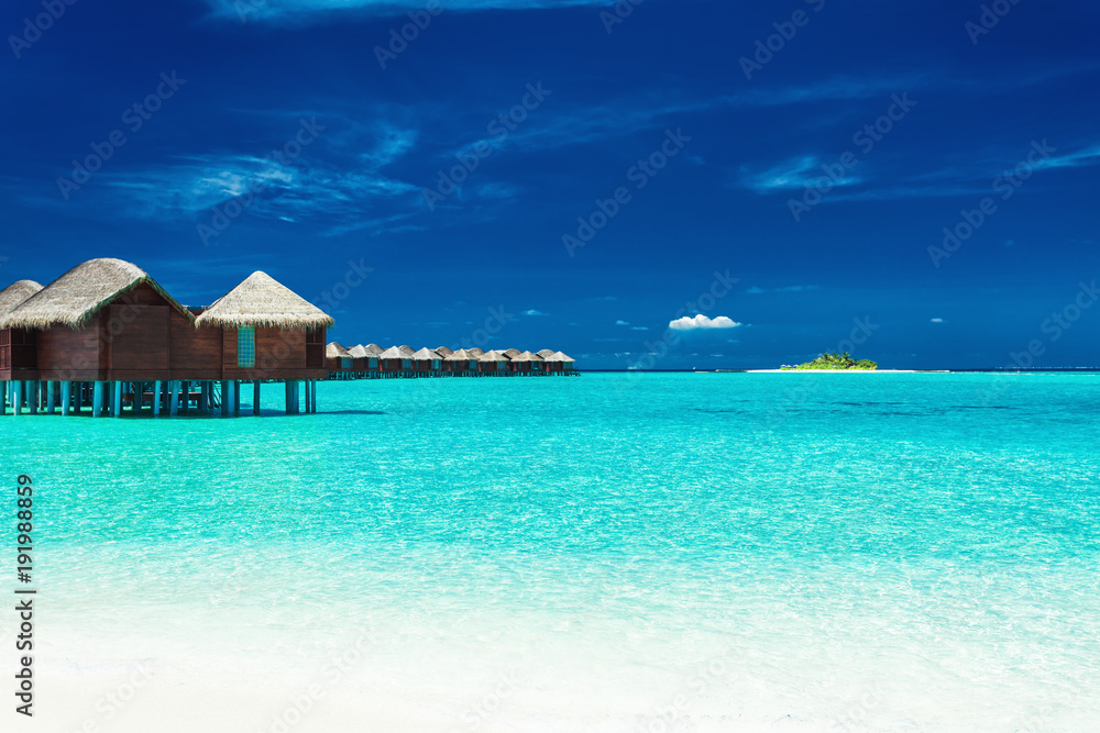 Over water bungalows with steps into lagoon, Maldives Over water bungalows with steps into lagoon, Maldives