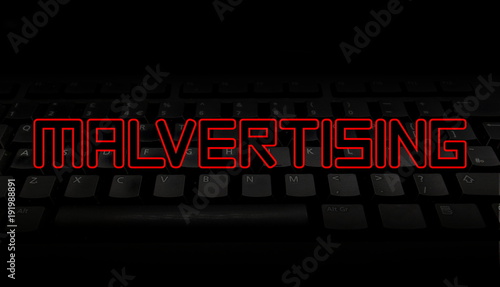 Malvertising red text over black keyboard illustration