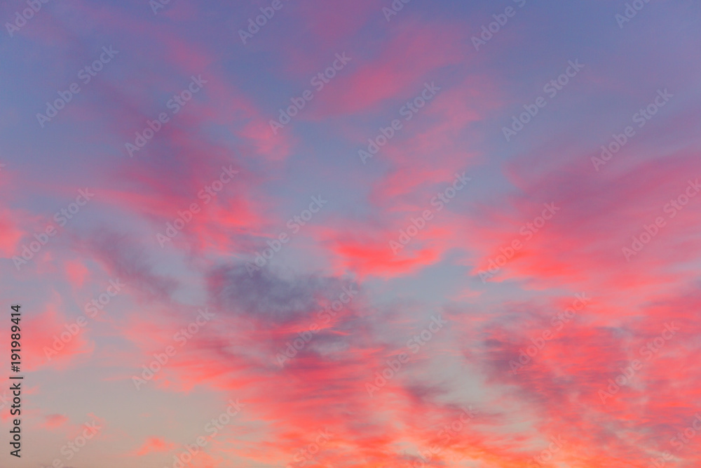 Pink purple sunset clouds on a blue sky. Colorfull abstract background