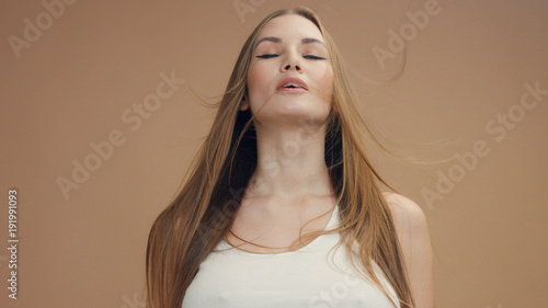 Photos deep breathing caucasian woman with hair moved by air