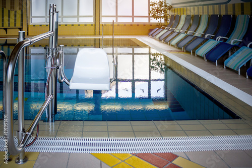 Chair lift in swimming pool for disabled people