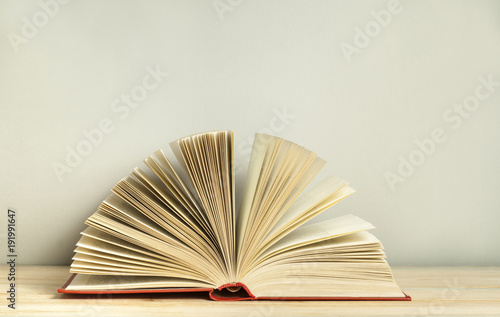 Open book on wooden table. Education background. Back to school. Free copy space.