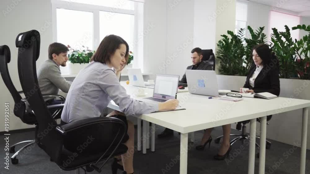 Business people working at a table in the office Business people working at a table in the office