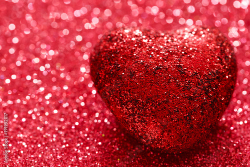 Brilliant red heart on a red shiny background. Macro. Valentine's Day. Postcard. 14 February. Space for text