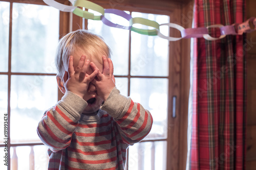 Boy playing hide and seek photo