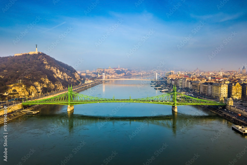 Budapest, Hungary - Aerial skyline view of beautiful Liberty Bridge on a sunny morning with Gellert Hill, Citadella, Statue of Liberty, Elisabeth Bridge and Buda Castle Royal Palace at background