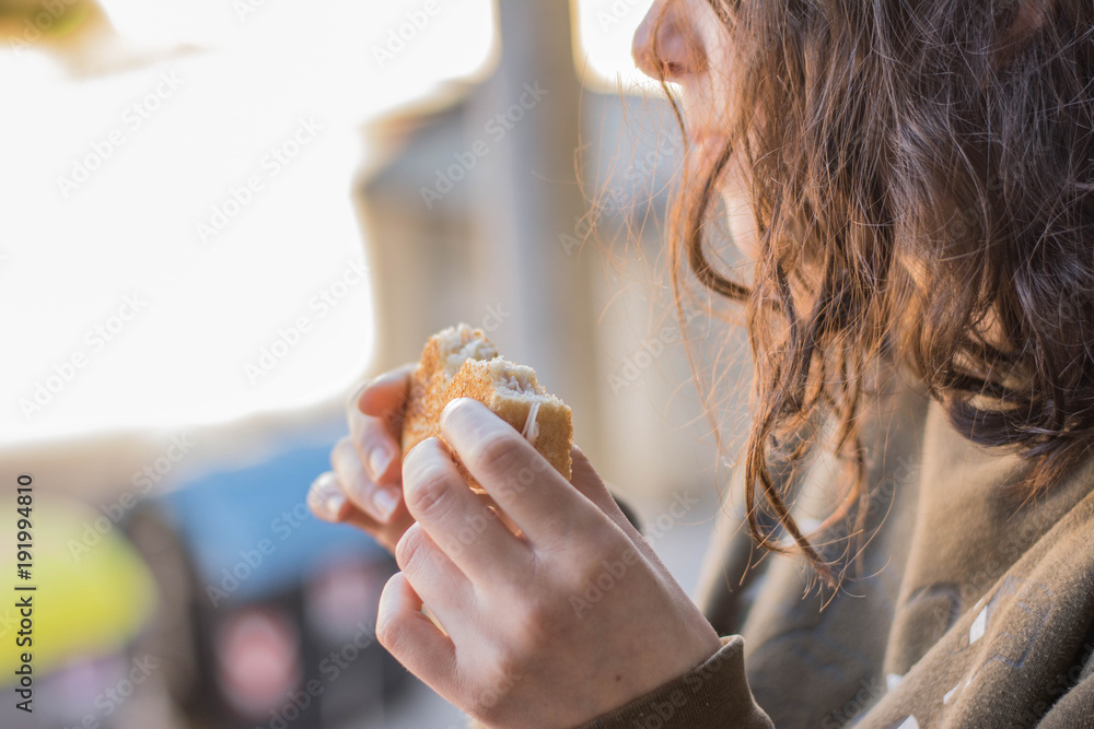 white girl eating a delicious grilled sandwich of sweet ham, cheese and butter with sandwich bread maked in a pan white girl eating a delicious grilled sandwich of sweet ham, cheese and butter with sandwich bread maked in a pan