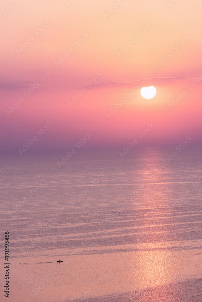 Nice pink sunset seascape in pastel shades, peace and calm outdoor travel background with copy space, vertical image
