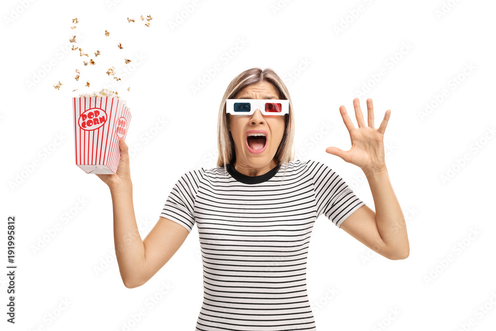 Naklejka premium Terrified young woman with 3D glasses and popcorn