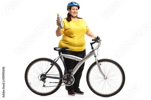 Overweight woman with a bicycle and a water bottle