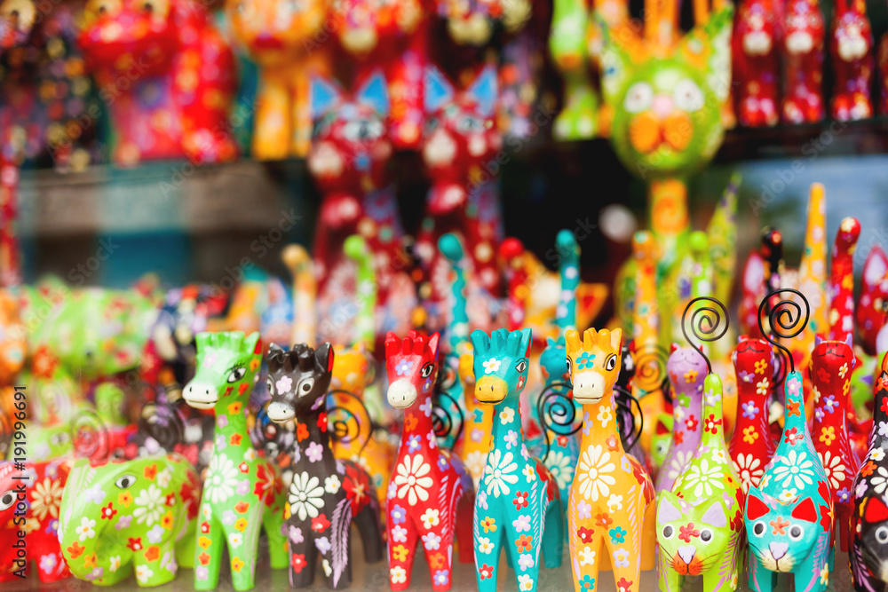 Sale of souvenirs - funny handmade wooden animals. Bright colorful children toys and decoration for interior. Ubud, Bali island, Indonesia.