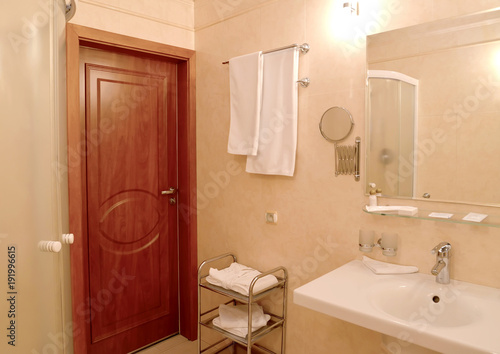 Bathroom interior with towels on a wall