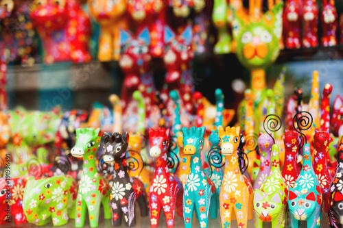 Sale of souvenirs - funny handmade wooden animals. Bright colorful children toys and decoration for interior. Ubud, Bali island, Indonesia. © Konstantin Aksenov