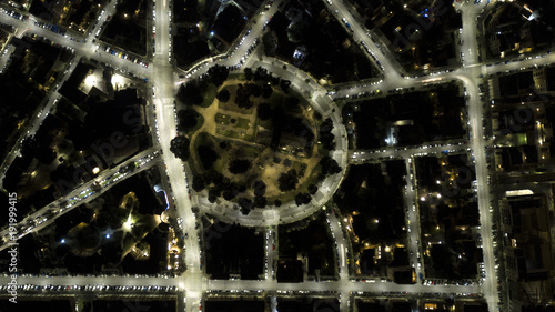 Perpendicular night view of Piazza di Villa Fiorelli in Rome, Italy. This is a pedestrian roundabout with a park. Around the green area there are the enlightened streets of the city with the cars. © Stefano Tammaro