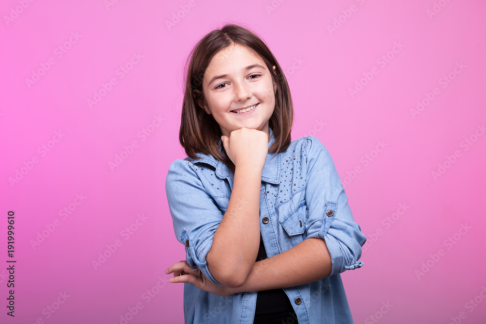 Portrait of happy smiling teenager on pink background in studio photo Portrait of happy smiling teenager on pink background in studio photo