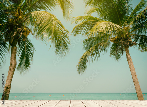 Palm trees coconut wood terrace beach sea sky in the summer of the holiday vintage toned