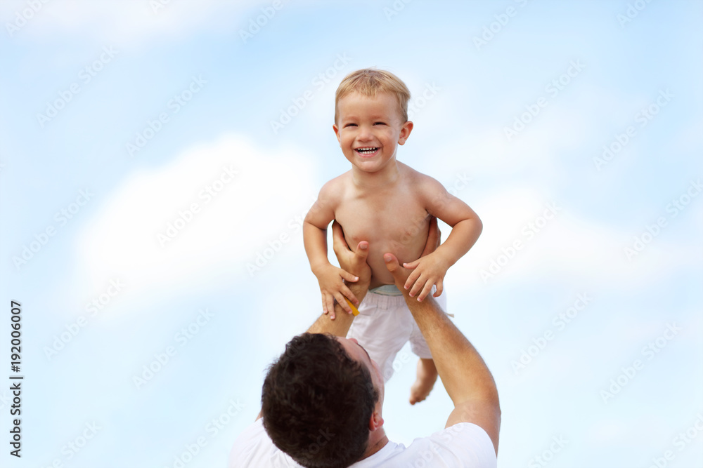 Father having fun on the beach with his little son Father having fun on the beach with his little son