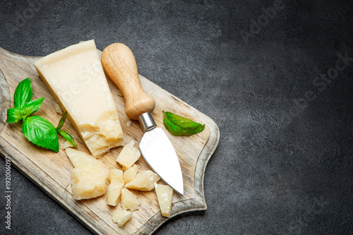 Pieces of parmesan cheese on concrete background