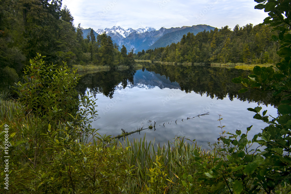 Nature scenery with peaceful lake of pristine clear water and mountain mirror reflection, New Zealand Landscape, Southern Alps Glaciers 