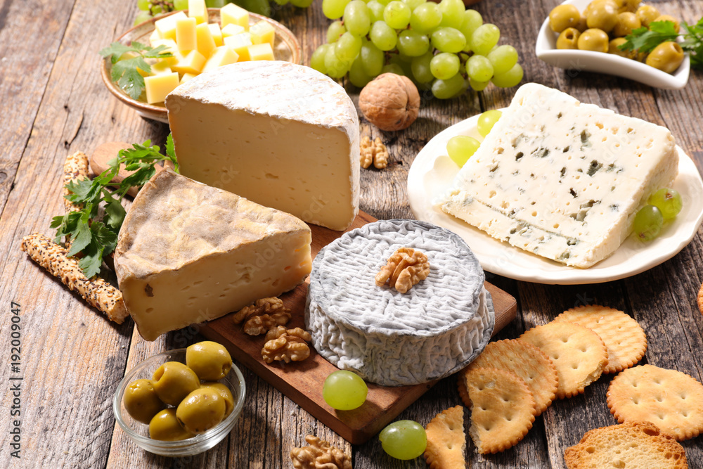 assorted cheese on wood background