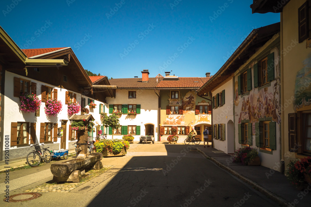 Traditional low-rise residential houses decorated with murals and plants in Mittenwald, Germany