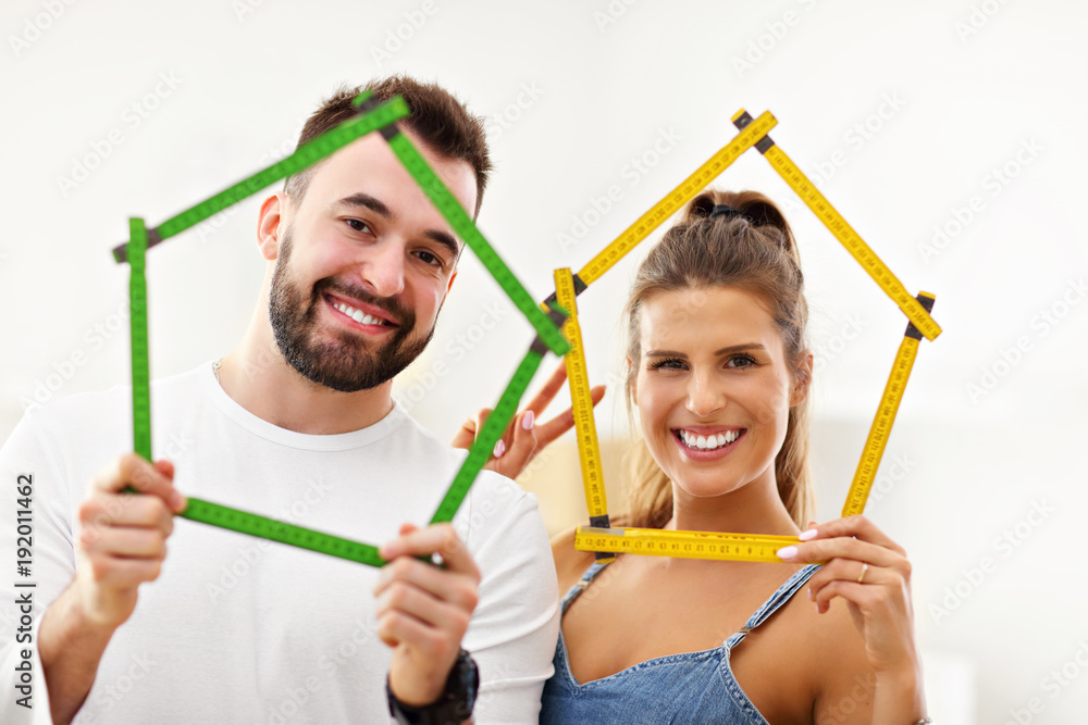 Happy adult couple moving out or in to new home Happy adult couple moving out or in to new home