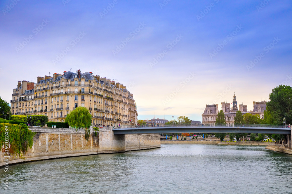 View of the embankment of the River Seine in the evening, the historic quarters of Paris