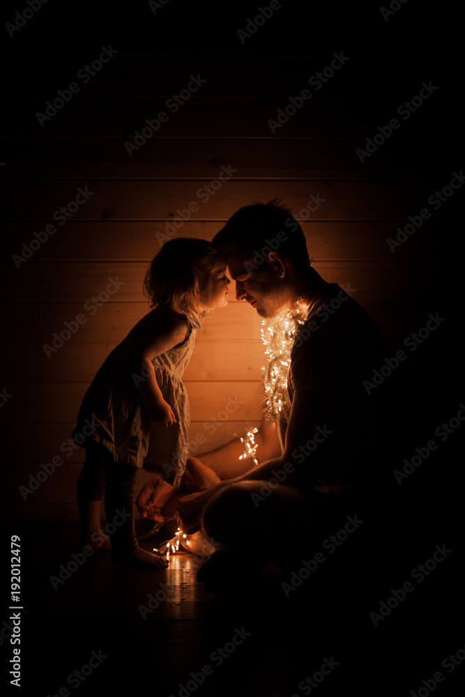Father and daughter with lights