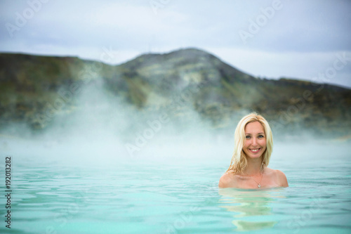 a girl relaxing in a blue lagoon in Iceland