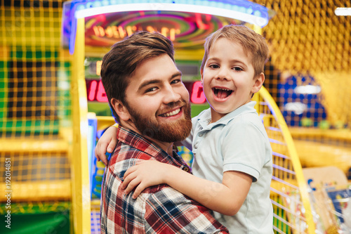 Cheerful little boy having fun with his dad