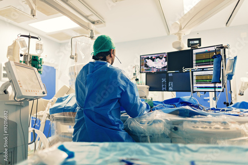 Cardiologist doing catheter ablation with radiofrequency energy using imaging system with fluoroscopic X-ray tube for interventional vascular procedures and electrophysiology. image guided system