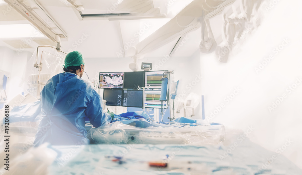 Αυτοκόλλητο Cardiologist doing catheter ablation with radiofrequency energy using imaging system with fluoroscopic X-ray tube for interventional vascular procedures and electrophysiology